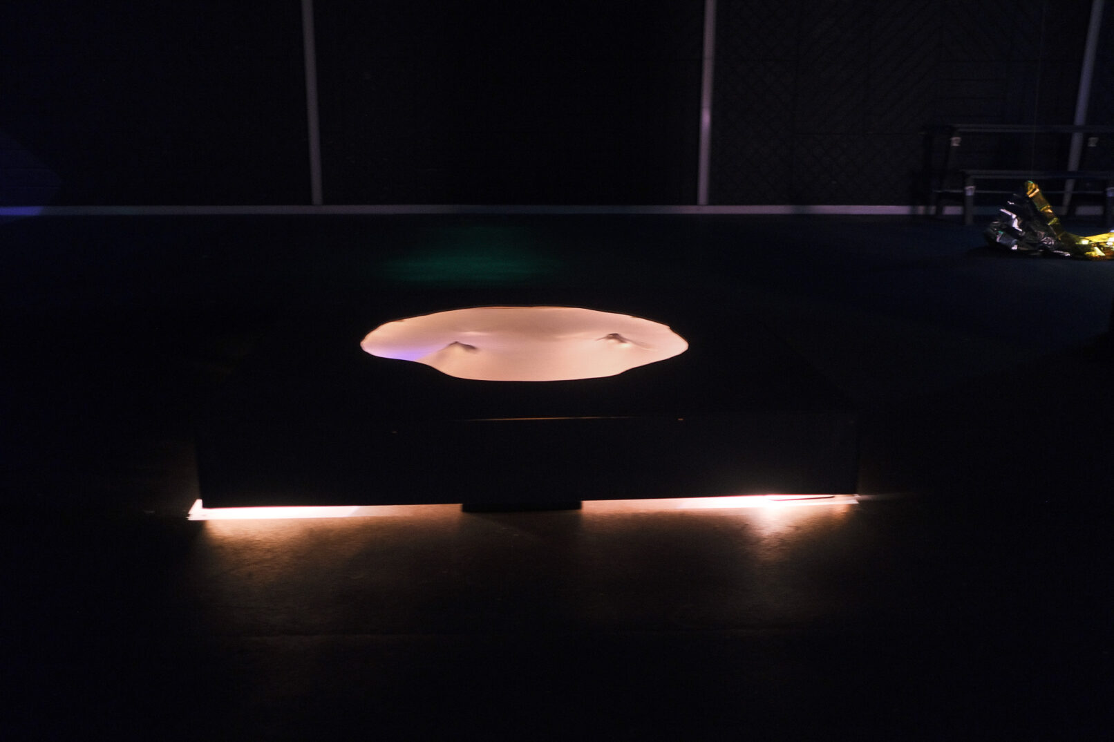 hole with light and a mechanism that pushes a semi transparent silicon