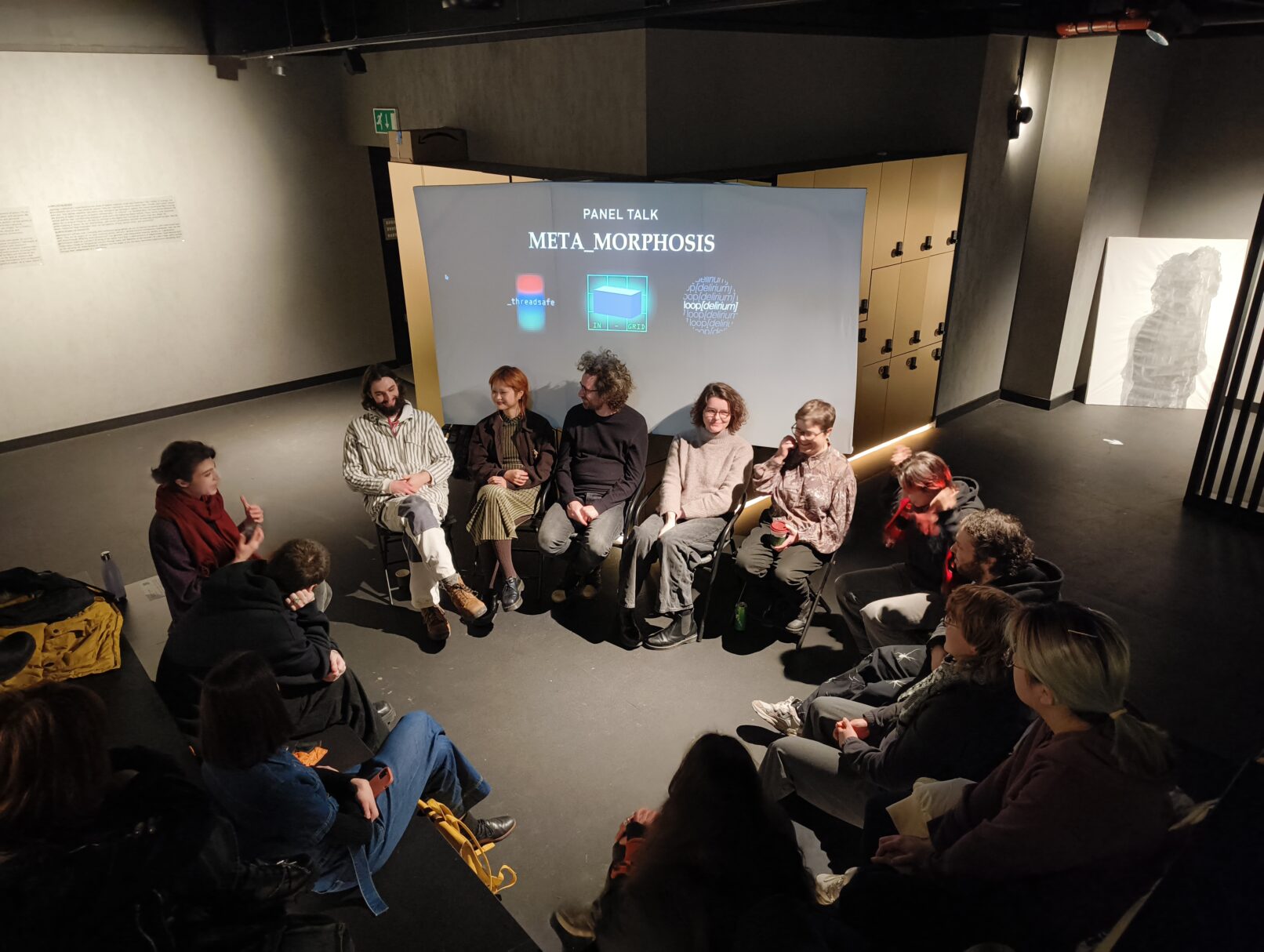 talks. many people gathered around the screening area