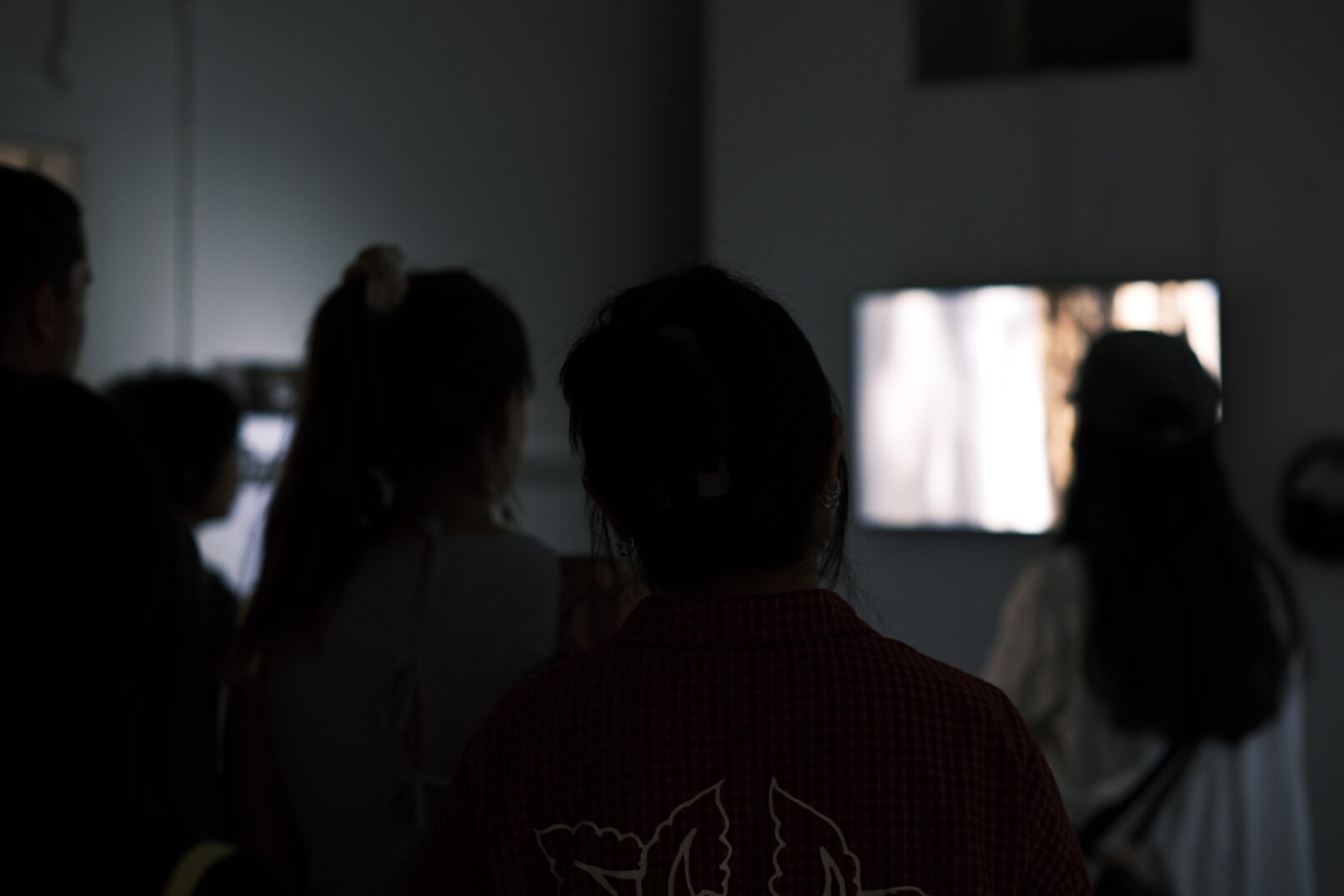 people watching the video documentation during the Goldmsmiths exhibition