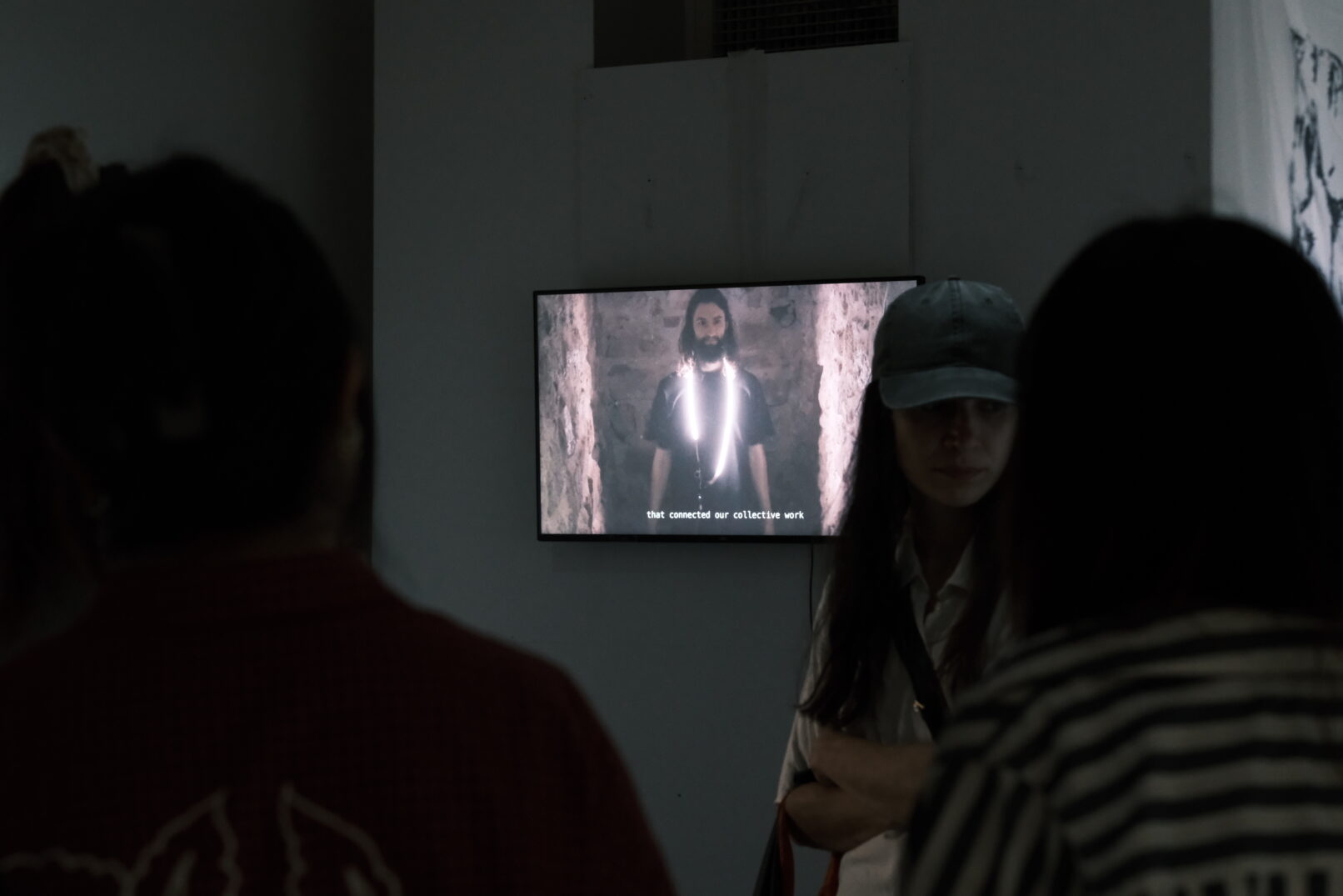 people watching the video documentation during the Goldmsmiths exhibition